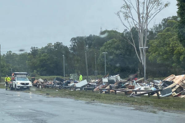 image-peter-psaltis-2022floods-clean-up_crews_pile_furniture_in_carina