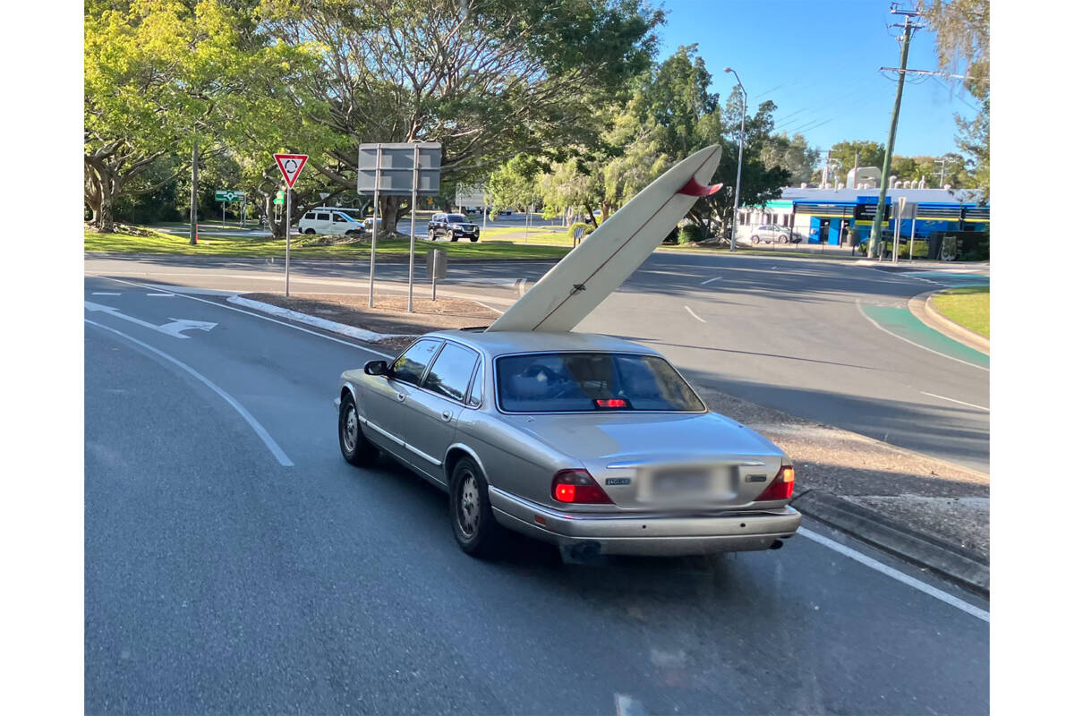 Article image for Surf’s up! Driver with surboard bursting through sunroof